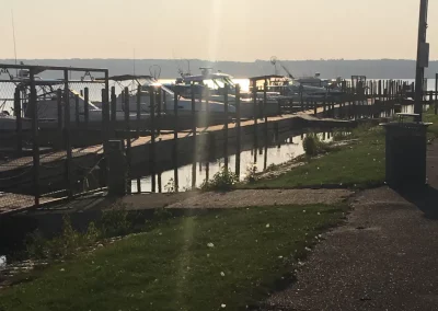 view of Baraga County Marina showing walking path to floating dock and boats lined up to it
