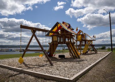 Baraga attractions - layground equipment at Capul Park with Baraga Marina in the background